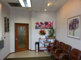 Reception and waiting area at Star Dental Practice with leather seating and floral artwork